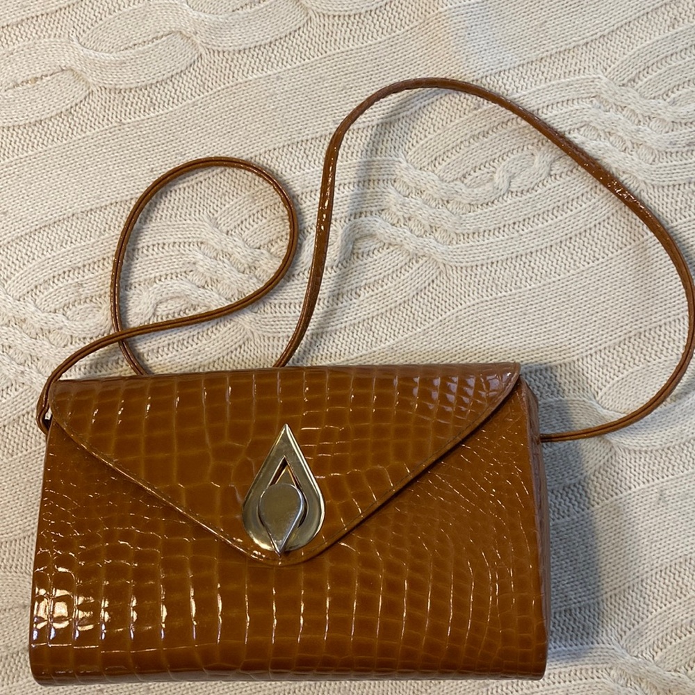 Crossbody Purse. Tan Gold Hardware. Black lining inside. Hard structure